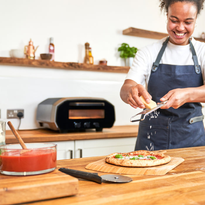 Ooni Volt 12 Electric Pizza Oven on kitchen counter | Click this image to open up the product gallery modal. The product gallery modal allows the images to be zoomed in on.