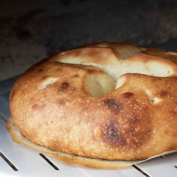 Olive Oil Bread on a perforated pizza peel