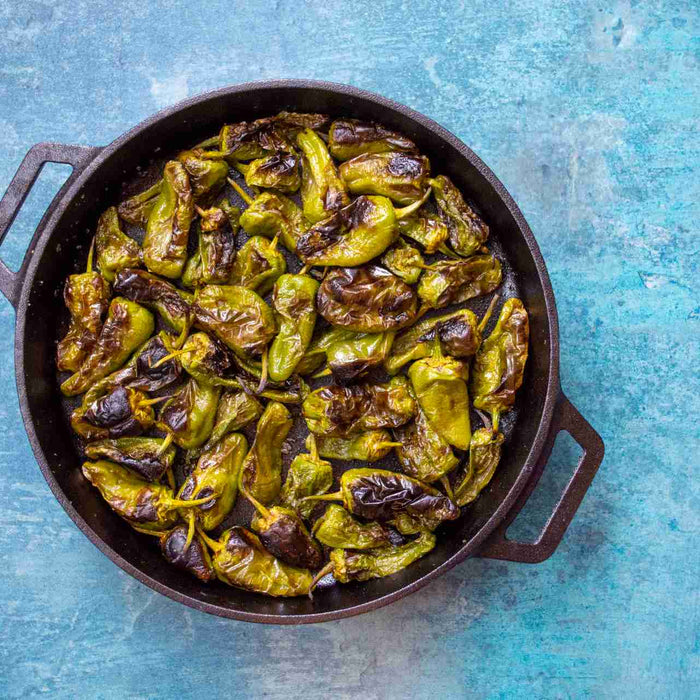 Blistered padrón peppers with flaked salt are the perfect handheld snack, easy to whip up and they will be gone in minutes.