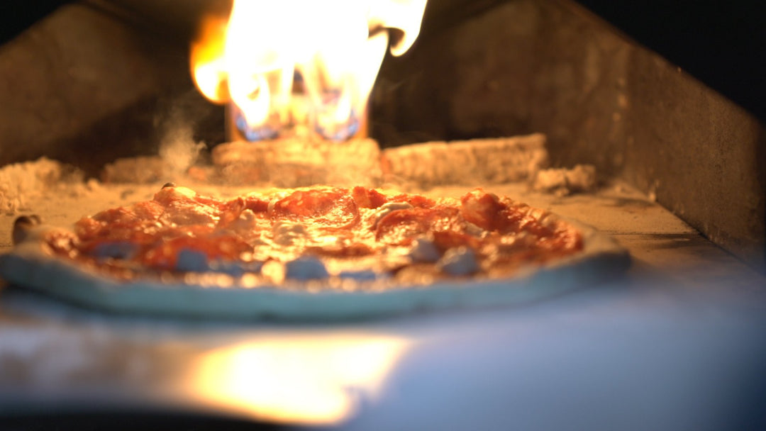 A pizza topped with haggis cooking in a pizza oven for Burns Night