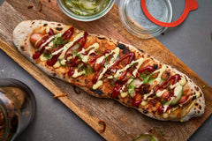 Pizza Hot Dogs with Quick-Pickled Cucumbers and Crispy Fried Onions