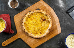 Welsh Rarebit Pizza served on a wooden pizza peel