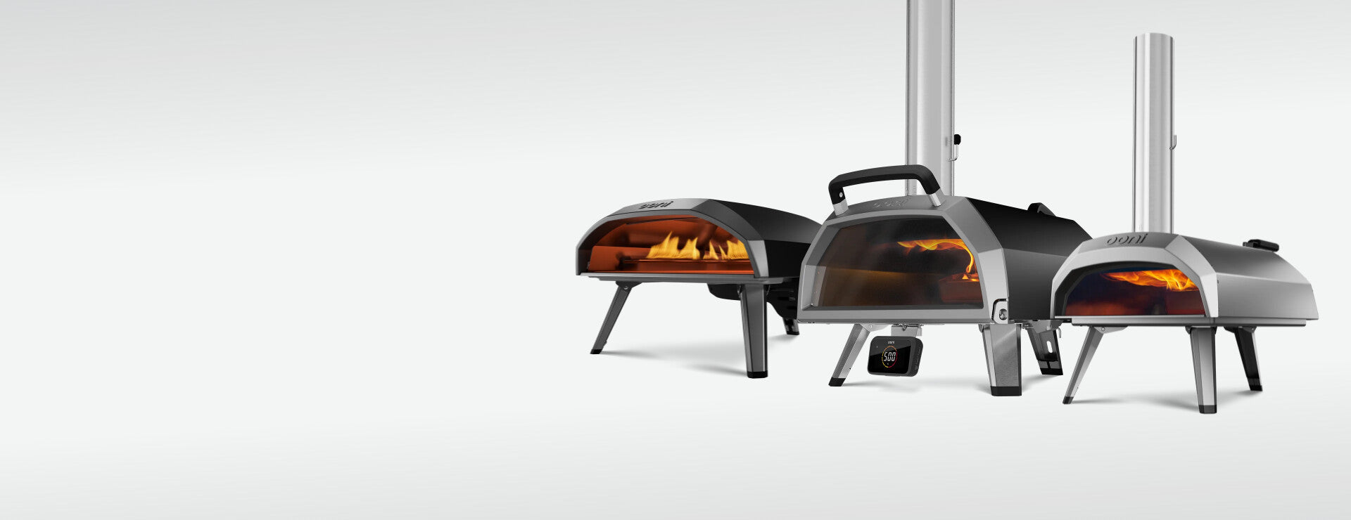 A stainless steel multi-fuel pizza oven with a hinged glass door.