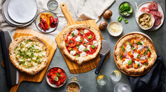 line up of infrared thermometer, turning peel and perforated pizza peel