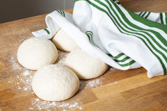 Pizza Dough balls with towel over