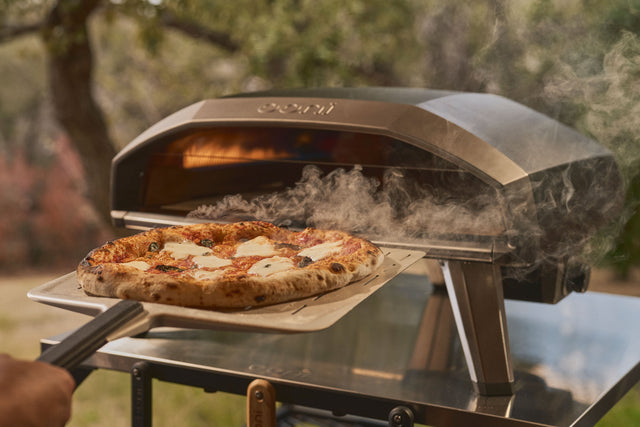 pizza being retrieved from ooni koda 2 pro