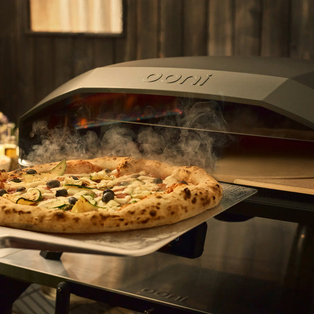 pizza being retrieved from the koda 2 max with rotating stone