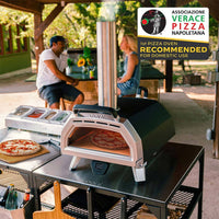 Karu 16 Pizza Oven with pizza baking inside on top of a modular table