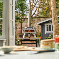 Ooni Karu 12G Pizza Oven on top of a modular table outdoors