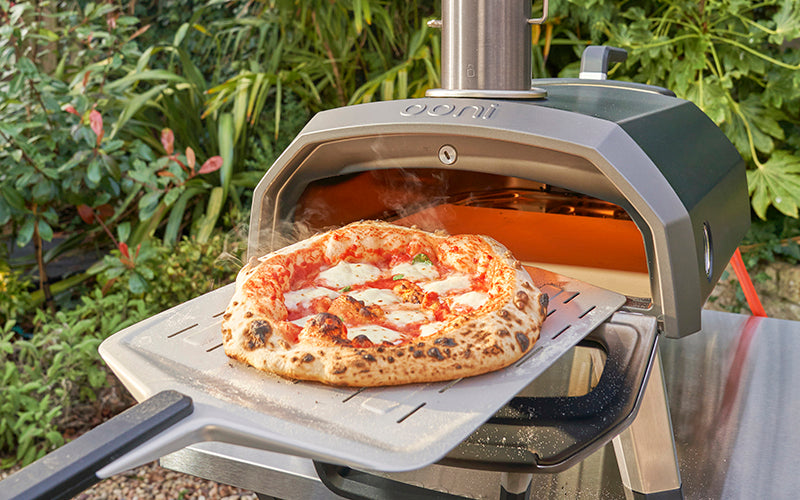 karu 12G oven with a perforated pizza peel