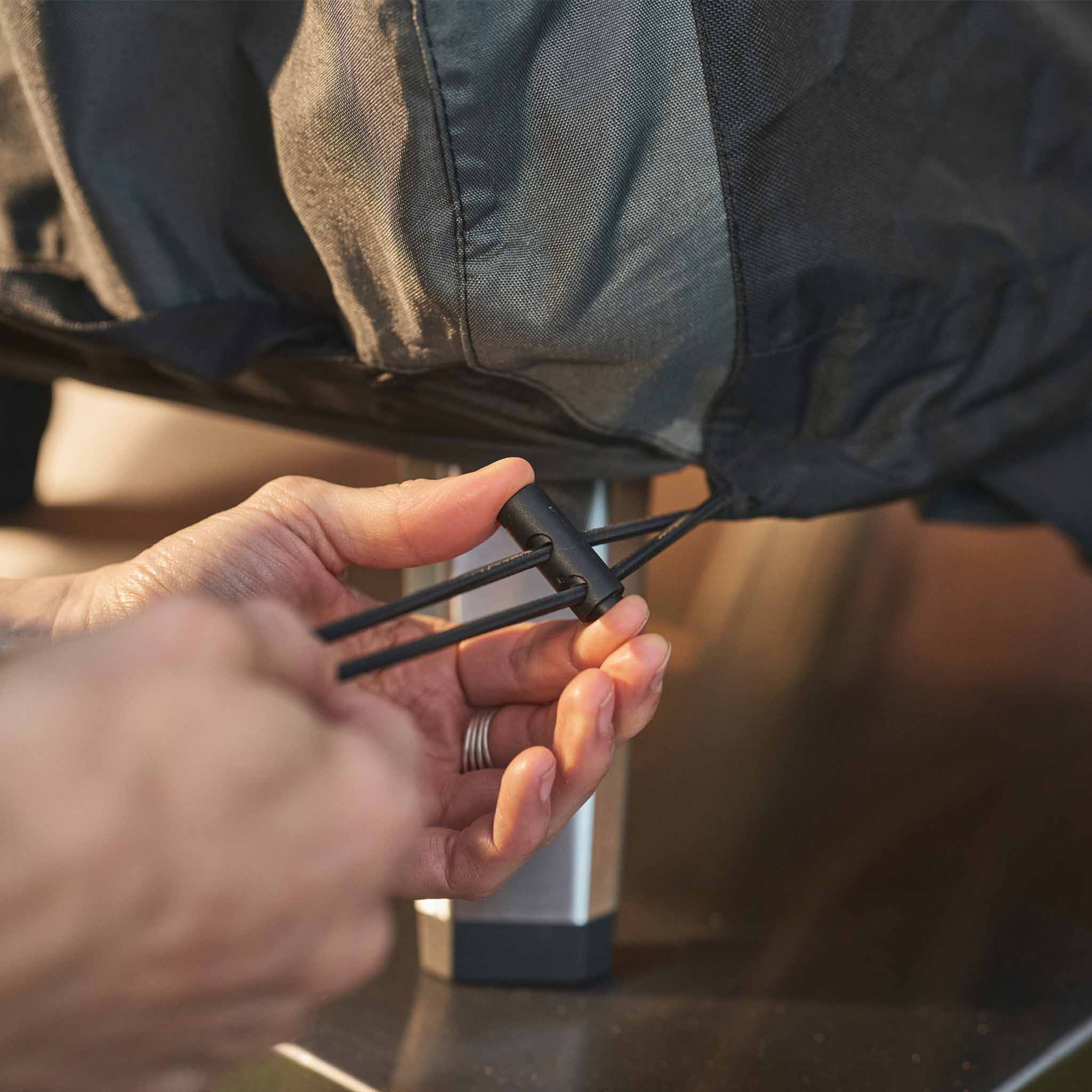 cord toggle being tightened on the koda 2 pro pizza oven cover