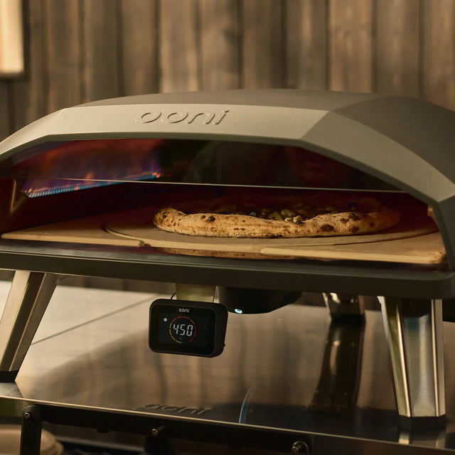 lifestyle asset of the Koda 2 Max with rotating stone with pizza in oven cooking
