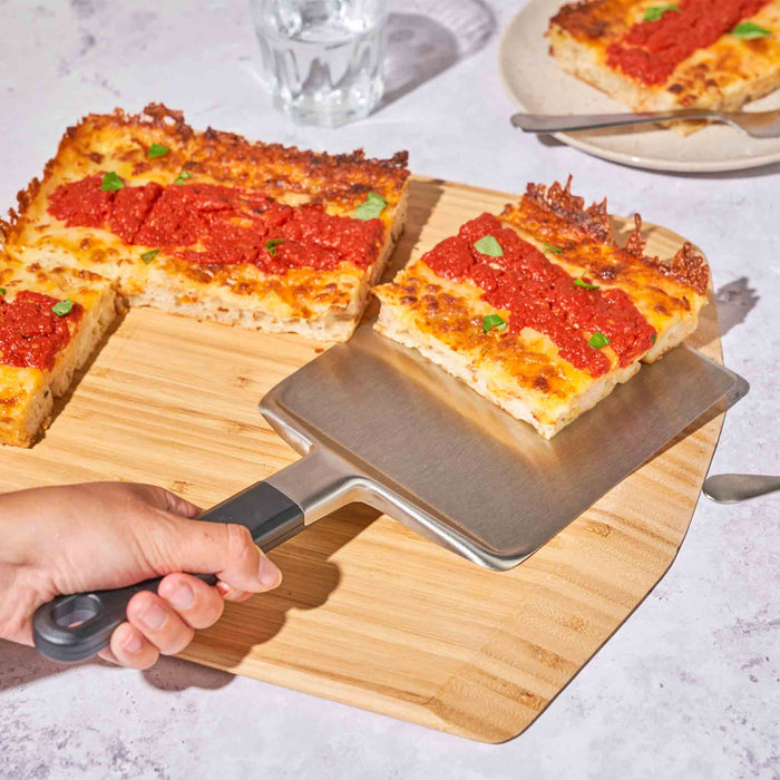Ooni Pan Pizza Spatula on Ooni Bamboo Serving Peel | Click this image to open up the product gallery modal. The product gallery modal allows the images to be zoomed in on.