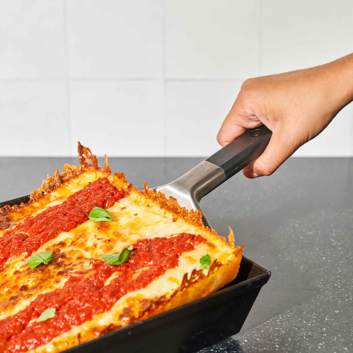 Ooni Pan Pizza Spatula lifting detroit-style pizza | Click this image to open up the product gallery modal. The product gallery modal allows the images to be zoomed in on.